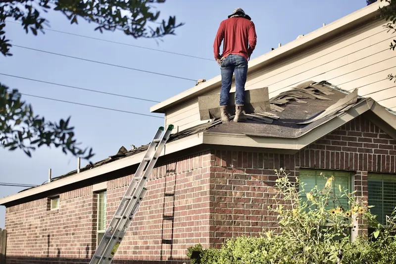 Professional roofer working on a residential roof in Town Park at Tradition